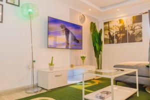 a living room with a couch and a table at Chic Modern Studio Apartment with Pool in Nanyuki