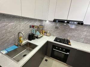 a kitchen with a sink and a stove top oven at The Nairobi Experience in Nairobi