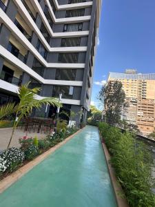 a river in front of a tall building at The Nairobi Experience in Nairobi