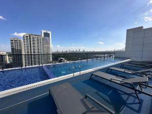 a swimming pool on the roof of a building with chairs at The Nairobi Experience in Nairobi