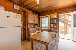 a kitchen with a table and a refrigerator at 5441 - Rascoe in Nags Head