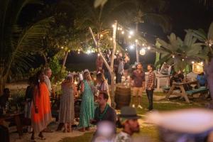 a group of people standing around a party at night at Surfers Bay in Christ Church