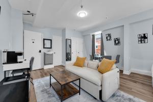 a living room with a couch and a table at Guestic Hotel at Queen West in Toronto