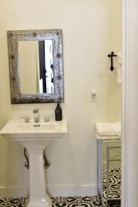 a bathroom with a white sink and a mirror at Lodge 3 on the Mason TX Square in Mason +2 photos