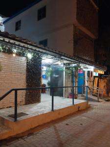 an empty street at night with lights on a building at Hotel Piedra del Mar in Puerto López