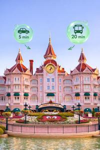 a large building with a clock tower in front of it at Disneyland Family Studio in Magny-le-Hongre