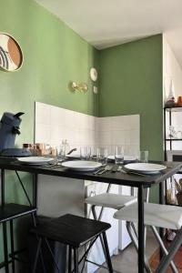 a table with chairs and wine glasses on it at Disneyland Family Studio in Magny-le-Hongre