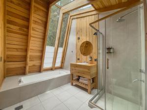 a bathroom with a tub and a sink and a shower at Glamping Vulcanche in Villa Traful +11 photos