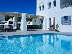 a swimming pool in front of a villa at Christou Estate & Villas in Pyrgos