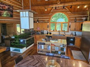a large kitchen with wooden floors and a large window at Vinewood Estate & Adventures in Purcellville