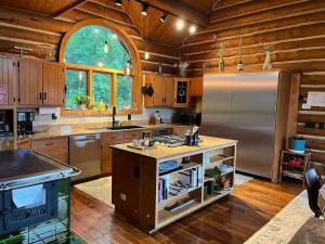 a large kitchen with wooden floors and a refrigerator at Vinewood Estate & Adventures in Purcellville +80 photos