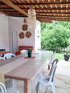 a dining room with a large wooden table and chairs at aguapé 1 in Barreirinhas +23 photos