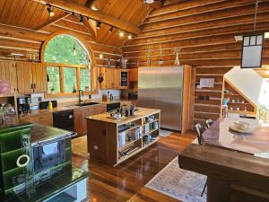a large kitchen with wooden walls and a wooden ceiling at Vinewood Estate & Adventures in Purcellville