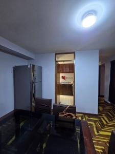 a living room with a couch and a refrigerator at Candela Apartment PUNO in Puno