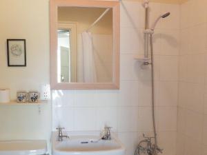 a bathroom with a sink and a shower with a mirror at Deer Park Lookout - E3928 in Thorpe Market