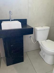 a bathroom with a sink and a toilet at Hotel Linassi in Cruz Alta