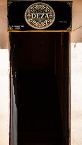 an entrance to a door with a sign on it at Hotel Deza in Lampa