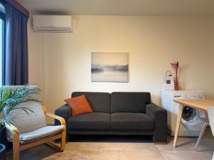 a living room with a couch and a table at Studio in Leuven in Leuven