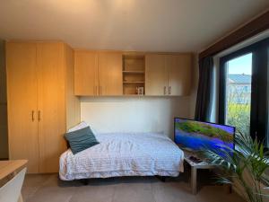 a small bedroom with a bed and a window at Studio in Leuven in Leuven