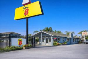 a sign for a fast food restaurant in front of a building at Super 8 by Wyndham Bakersfield CA Near Airport in Bakersfield