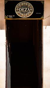 an open door with a sign on top of it at Hotel Deza in Lampa