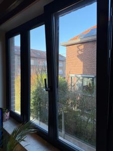 a window with a view of a brick building at Studio in Leuven in Leuven