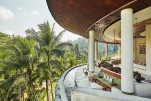a building with a view of a resort with palm trees at Four Seasons Resort Bali at Sayan in Ubud