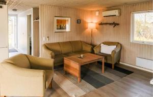 a living room with a couch and chairs and a table at 4 Bedroom Amazing Home In Ørsted in Ørsted