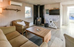 a living room with a couch and a wood stove at 4 Bedroom Amazing Home In Ørsted in Ørsted