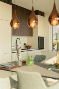 a kitchen with a table and some lights at Villa Vallonga in Bardolino