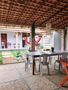a patio with a table and chairs and a playground at Aguapé quarto 3 in Barreirinhas +24 photos