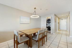 a dining room with a wooden table and chairs at Phoenix I 1142 in Orange Beach
