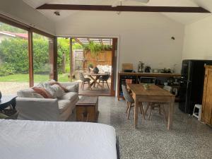 a living room with a couch and a table at Mini Mullum Studio Retreat in Mullumbimby