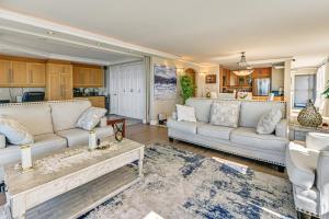 a living room with two couches and a table at Beachfront, Amazing 180-Degree View in Oceanside