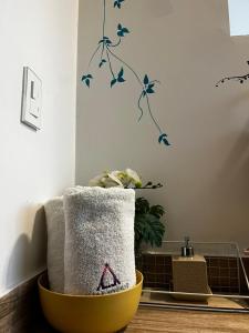 a room with two towels in a yellow bowl at Casa Antade Cusco in Cusco +202 photos