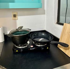 a pan sitting on top of a stove in a kitchen at CDE House in Ciudad del Este