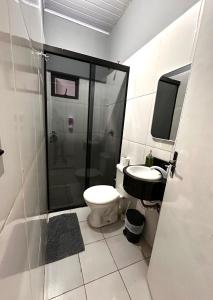 a bathroom with a shower and a toilet and a sink at CDE House in Ciudad del Este +3 photos