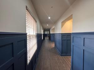 a room with blue cabinets and a hallway at HNFC Stays - Harmony Accommodation in Elswick +1 photo