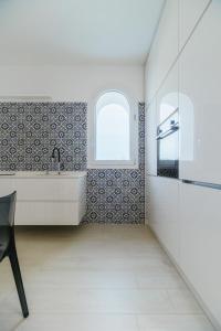 a bathroom with a tub and a sink and a window at Azuleyos Garden & Pool fronte mare in Marcelli