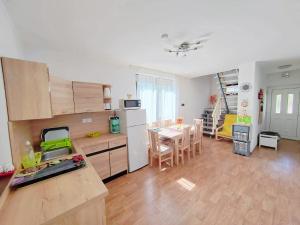 a kitchen and dining room with a table and a kitchen and a dining room at Maja Anna Vendégház in Bogács