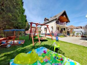 a yard with a playground and a swing at Maja Anna Vendégház in Bogács