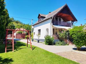 a house with a playground in front of it at Maja Anna Vendégház in Bogács
