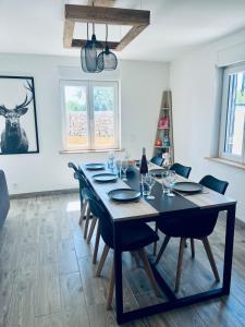 a dining room with a black table and chairs at Maison avec Jacuzzi - Europa-Park in Obenheim