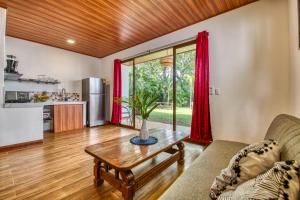 a living room with a couch and a table at Beachfront Studio - Direct Beach Access - Fast Wifi & AC in Cocles +30 photos