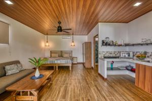 a living room with a couch and a table at Beachfront Studio - Direct Beach Access - Fast Wifi & AC in Cocles