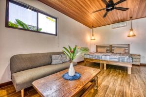 a living room with a couch and a table at Beachfront Studio - Direct Beach Access - Fast Wifi & AC in Cocles