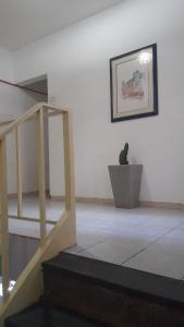 a staircase in a room with a bird sitting in a pot at Hotel Baguari in São Paulo