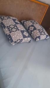 two pillows sitting on top of a bed at Hotel Baguari in São Paulo