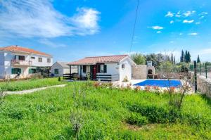 a villa with a pool and a house at House Ara in Grohote