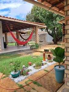 a garden with a hammock and some plants at Aguapé quarto 3 in Barreirinhas
